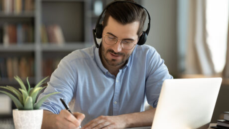 Focused,35s,Man,Sit,At,Desk,Wear,Headphones,Watch,Webinar