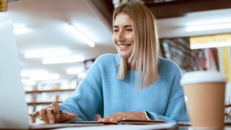 Education,,University,And,Happy,Woman,In,Library,With,Laptop,,Research