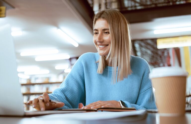 Education,,University,And,Happy,Woman,In,Library,With,Laptop,,Research